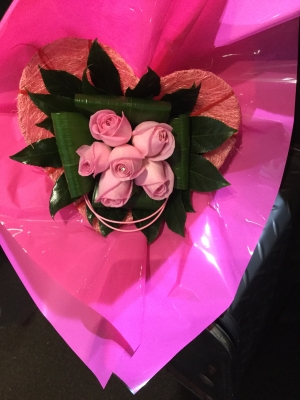 6 pink roses in a pink heart shaped holder
